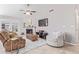 Cozy living room featuring a stone fireplace, plush seating, and a ceiling fan at 1582 W Chicago St, Chandler, AZ 85224