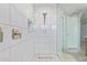 Tiled shower features a glass door, rainfall shower head, and a built-in niche for toiletries at 1582 W Chicago St, Chandler, AZ 85224