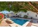 Inviting backyard swimming pool with lounge seating, mature trees, and tranquil atmosphere at 1582 W Chicago St, Chandler, AZ 85224