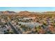 Stunning aerial view of the neighborhood highlighting the golf course and mountain backdrop at sunset at 1708 W Harmont Dr, Phoenix, AZ 85021