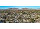 Expansive aerial view of the city showcasing a neighborhood nestled against mountains under a clear blue sky at 1708 W Harmont Dr, Phoenix, AZ 85021