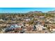 Expansive aerial view of a suburban neighborhood nestled against a scenic mountain backdrop at 1708 W Harmont Dr, Phoenix, AZ 85021