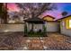 Relaxing backyard featuring a gazebo, decorative stone, and ambient lighting at 1708 W Harmont Dr, Phoenix, AZ 85021