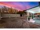 Spacious backyard features gravel, covered patio, and decorative rock accents at 1708 W Harmont Dr, Phoenix, AZ 85021