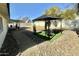 Beautiful backyard featuring a gazebo, decorative rock landscaping, and a paved walkway, perfect for outdoor entertaining at 1708 W Harmont Dr, Phoenix, AZ 85021