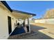 Cozy backyard patio with outdoor seating, decorative curtains, and manicured landscaping at 1708 W Harmont Dr, Phoenix, AZ 85021