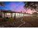 The cozy backyard offers gravel and rock landscaping with a covered patio at 1708 W Harmont Dr, Phoenix, AZ 85021