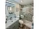 Modern bathroom features a glass-enclosed shower, a large mirror with decorative lighting, and stylish fixtures at 1708 W Harmont Dr, Phoenix, AZ 85021