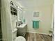 Bright bathroom with a shower, decorative backsplash, and a built-in storage cabinet at 1708 W Harmont Dr, Phoenix, AZ 85021