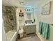 Bathroom featuring tub with marble-like tile surround, shower, and stylish vanity, creating a modern spa-like retreat at 1708 W Harmont Dr, Phoenix, AZ 85021