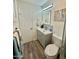 Well-lit bathroom with a modern vanity, mirror, toilet, and shower with glass doors, plus stylish fixtures at 1708 W Harmont Dr, Phoenix, AZ 85021
