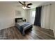 Cozy bedroom featuring wood-look floors, ceiling fan, and neutral decor at 1708 W Harmont Dr, Phoenix, AZ 85021