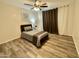 Modest bedroom with wood floors and an overhead fan and light combo at 1708 W Harmont Dr, Phoenix, AZ 85021