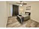 Comfortable bedroom with wood-look floors, a ceiling fan, and neutral decor at 1708 W Harmont Dr, Phoenix, AZ 85021