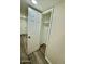 View of closet with open white door, shelf, and rod, in a neutral color room with wood-like flooring at 1708 W Harmont Dr, Phoenix, AZ 85021