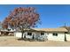 Charming single-story home with a well-manicured front yard and mature trees at 1708 W Harmont Dr, Phoenix, AZ 85021