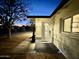 Inviting front entrance with a well-lit porch and neatly landscaped surroundings at 1708 W Harmont Dr, Phoenix, AZ 85021