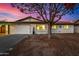 Charming single-story home featuring a well-maintained yard, covered entryway, and attached garage at 1708 W Harmont Dr, Phoenix, AZ 85021