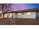 Charming single-story home featuring manicured landscaping and warm lighting at 1708 W Harmont Dr, Phoenix, AZ 85021