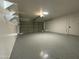 The spacious garage features a freshly painted epoxy floor and overhead shelving at 1708 W Harmont Dr, Phoenix, AZ 85021