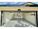 View of garage with epoxy floor, laundry area, and shelving from the outside at 1708 W Harmont Dr, Phoenix, AZ 85021