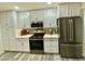 Updated kitchen featuring stainless steel appliances and white cabinets, offering a modern aesthetic at 1708 W Harmont Dr, Phoenix, AZ 85021