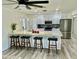 Bright kitchen with modern appliances, a large island with seating, and stylish pendant lighting at 1708 W Harmont Dr, Phoenix, AZ 85021
