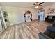 Bright living room featuring wood-look floors, neutral walls, modern decor, and a ceiling fan at 1708 W Harmont Dr, Phoenix, AZ 85021