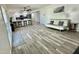 Spacious living area with a kitchen view, neutral flooring, and modern decor at 1708 W Harmont Dr, Phoenix, AZ 85021
