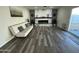 Bright living room with modern fireplace, light gray floors, and comfortable seating at 1708 W Harmont Dr, Phoenix, AZ 85021