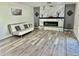 Open-concept living room with modern fireplace, contemporary furniture, and neutral flooring at 1708 W Harmont Dr, Phoenix, AZ 85021