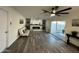 Open-concept living room with sleek fireplace, light gray floors, and sliding glass door at 1708 W Harmont Dr, Phoenix, AZ 85021