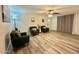 Living room featuring neutral flooring, modern decor, and comfortable armchairs at 1708 W Harmont Dr, Phoenix, AZ 85021
