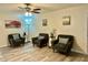 Inviting living room area with three chairs, modern artwork, and neutral flooring at 1708 W Harmont Dr, Phoenix, AZ 85021