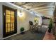 Cozy covered outdoor patio features lighting, bar seating, and backyard access at 1708 W Harmont Dr, Phoenix, AZ 85021