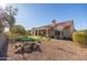 Landscaped backyard with fire pit and putting green at 18603 N Twilight Way, Surprise, AZ 85374