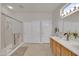 Clean bathroom with double vanity, shower, and linen closet at 18603 N Twilight Way, Surprise, AZ 85374