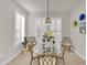 Bright dining area with glass table and four chairs, natural light at 18603 N Twilight Way, Surprise, AZ 85374
