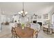 Elegant dining room with a chandelier and open view to the living area at 18603 N Twilight Way, Surprise, AZ 85374