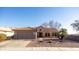 Single-story home with a terracotta tile roof and attached two-car garage at 18603 N Twilight Way, Surprise, AZ 85374