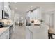 White kitchen with an island and breakfast bar, overlooking the dining area at 18603 N Twilight Way, Surprise, AZ 85374