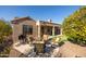 Back patio with seating area and grill, next to putting green at 18603 N Twilight Way, Surprise, AZ 85374