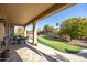 Covered patio with dining table and putting green in background at 18603 N Twilight Way, Surprise, AZ 85374