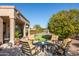 Relaxing patio furniture on a stone patio next to putting green at 18603 N Twilight Way, Surprise, AZ 85374