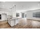 Open concept living area with kitchen island and wood-look tile floors at 20019 W Campbell Ave, Buckeye, AZ 85396