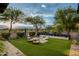 Beautiful backyard featuring a water feature, comfortable seating around a fire pit, and mature desert landscaping at 20653 N 101St St, Scottsdale, AZ 85255