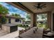 Outdoor living space with kitchen, dining, tv and pool at 20653 N 101St St, Scottsdale, AZ 85255