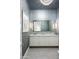 Elegant powder room with a gray textured wall, mosaic tile, and white vanity at 21487 N 110Th Pl, Scottsdale, AZ 85255