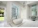 Spa-like bathroom with a large soaking tub, walk-in shower, and marble floors at 21487 N 110Th Pl, Scottsdale, AZ 85255