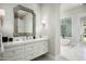 Bright bathroom with a white vanity, large mirror, and a view of the shower and tub at 21487 N 110Th Pl, Scottsdale, AZ 85255